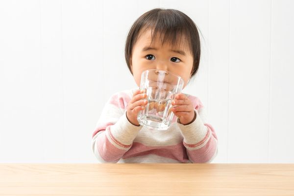 kid drinking water from cup