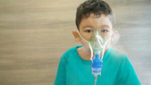 child treated for wheezing with nebuliser
