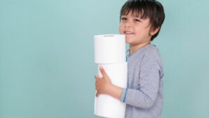 child holding toilet paper